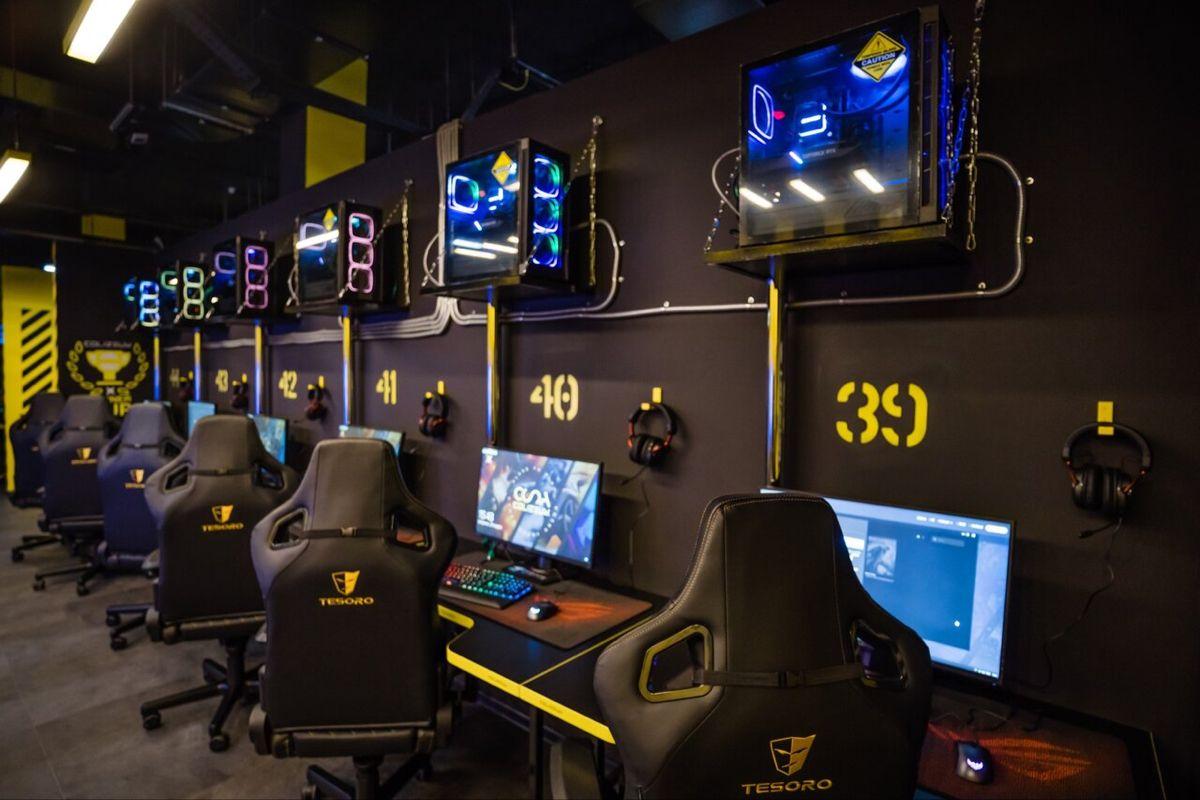 Gaming cafe interior with a glowing LEVEL UP neon sign